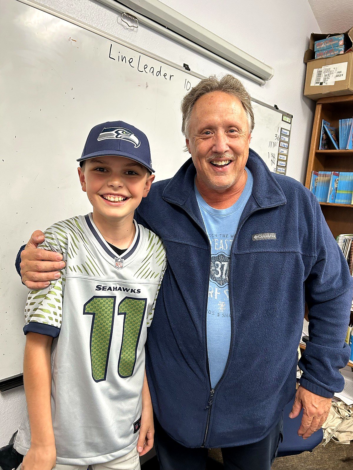 A Spring Mountain student in a sports jersey with his teacher