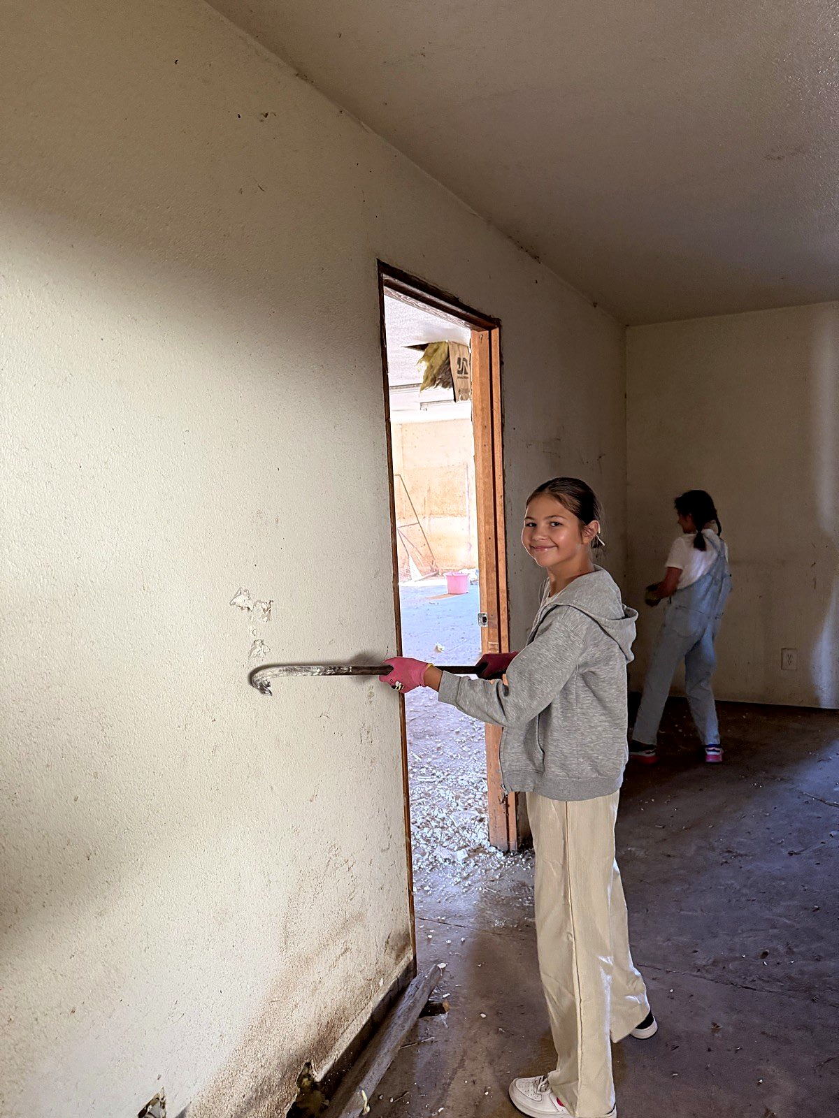A Spring Mountain student rolling up her sleeves for a hands-on service project