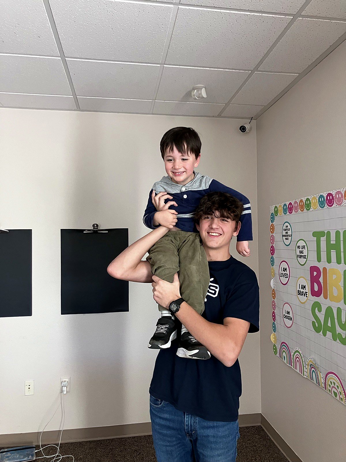 An older Spring Mountain student mentoring a younger child