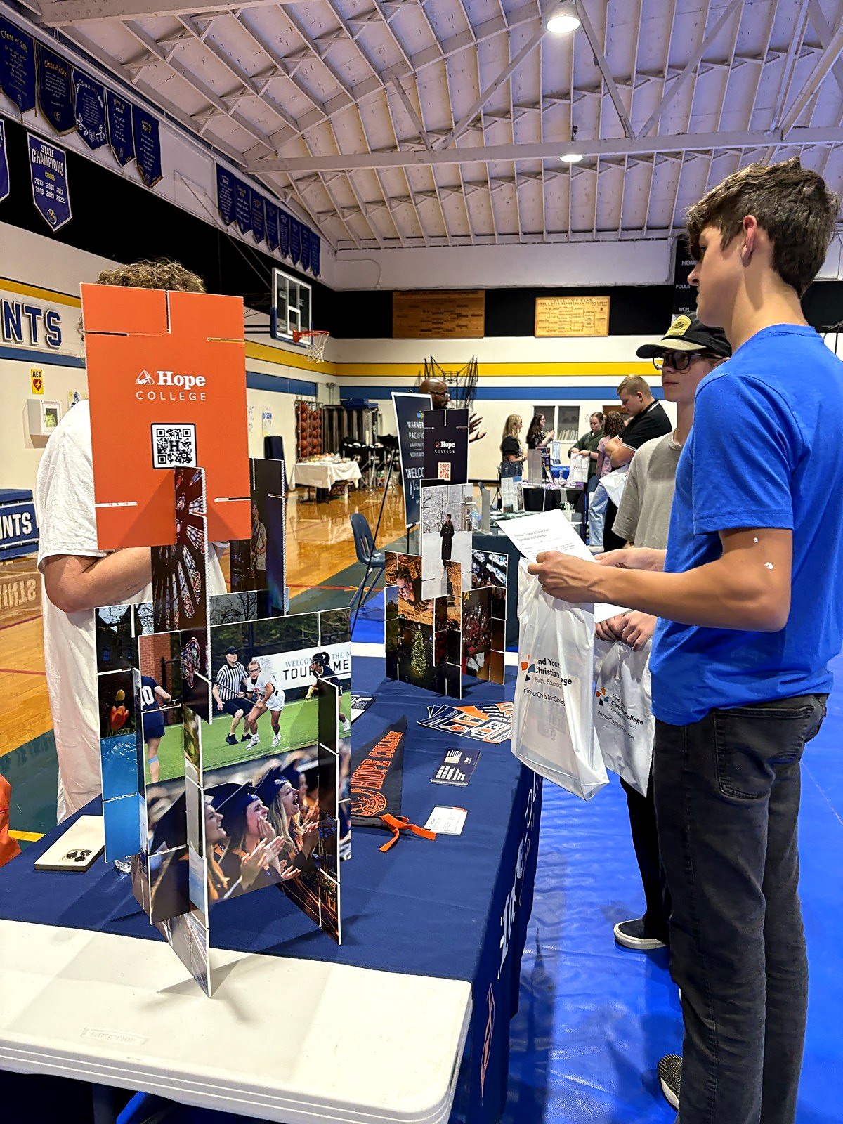 A Spring Mountain high school student talking with a college recruiter at a college fair