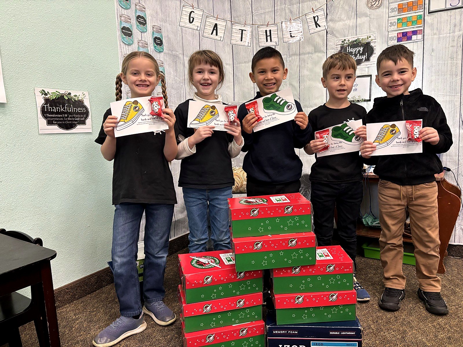 Smiling Spring Mountain elementary students with Operation Christmas Child shoeboxes