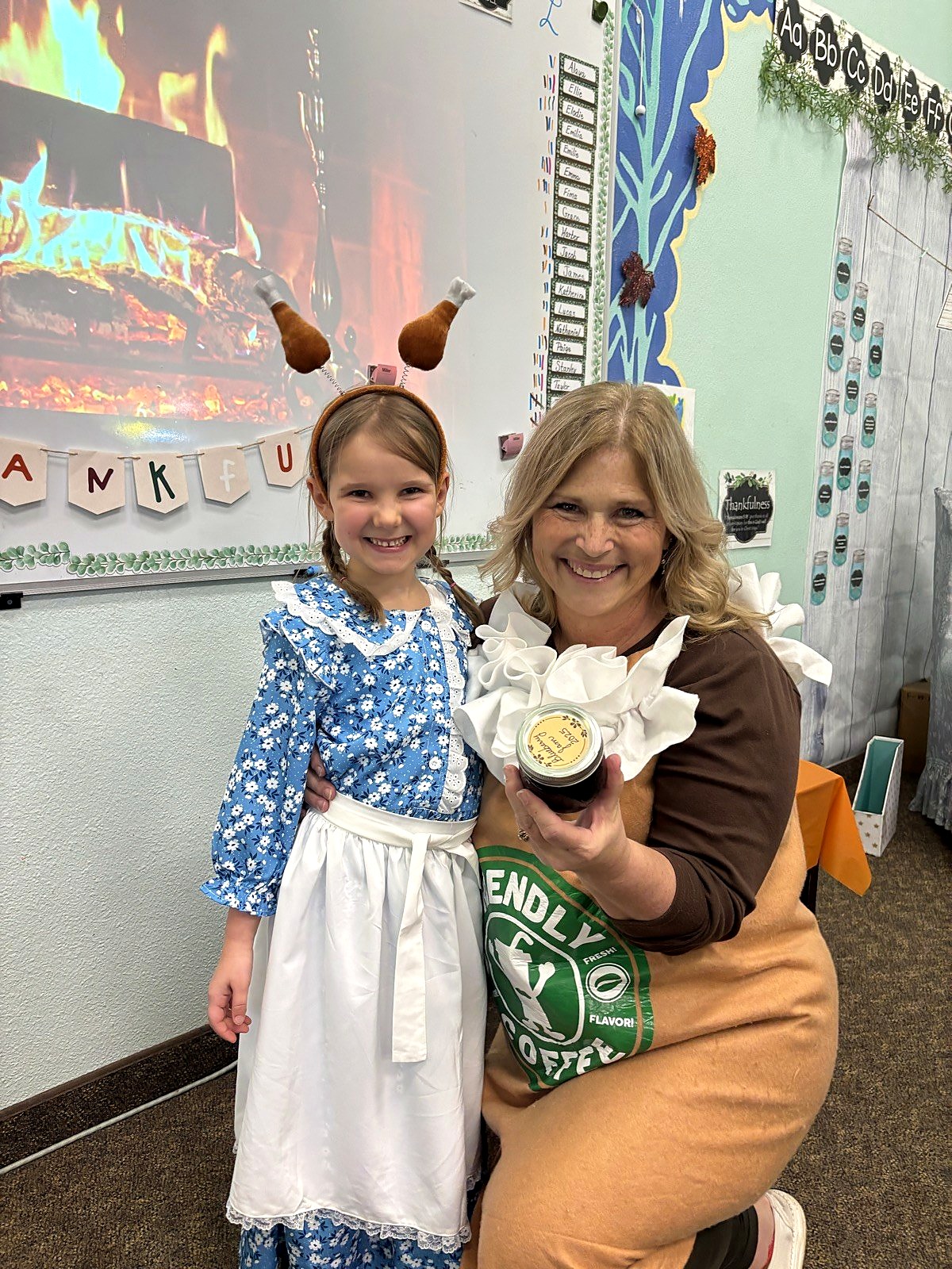 A Spring Mountain teacher and a young student at a classroom celebration